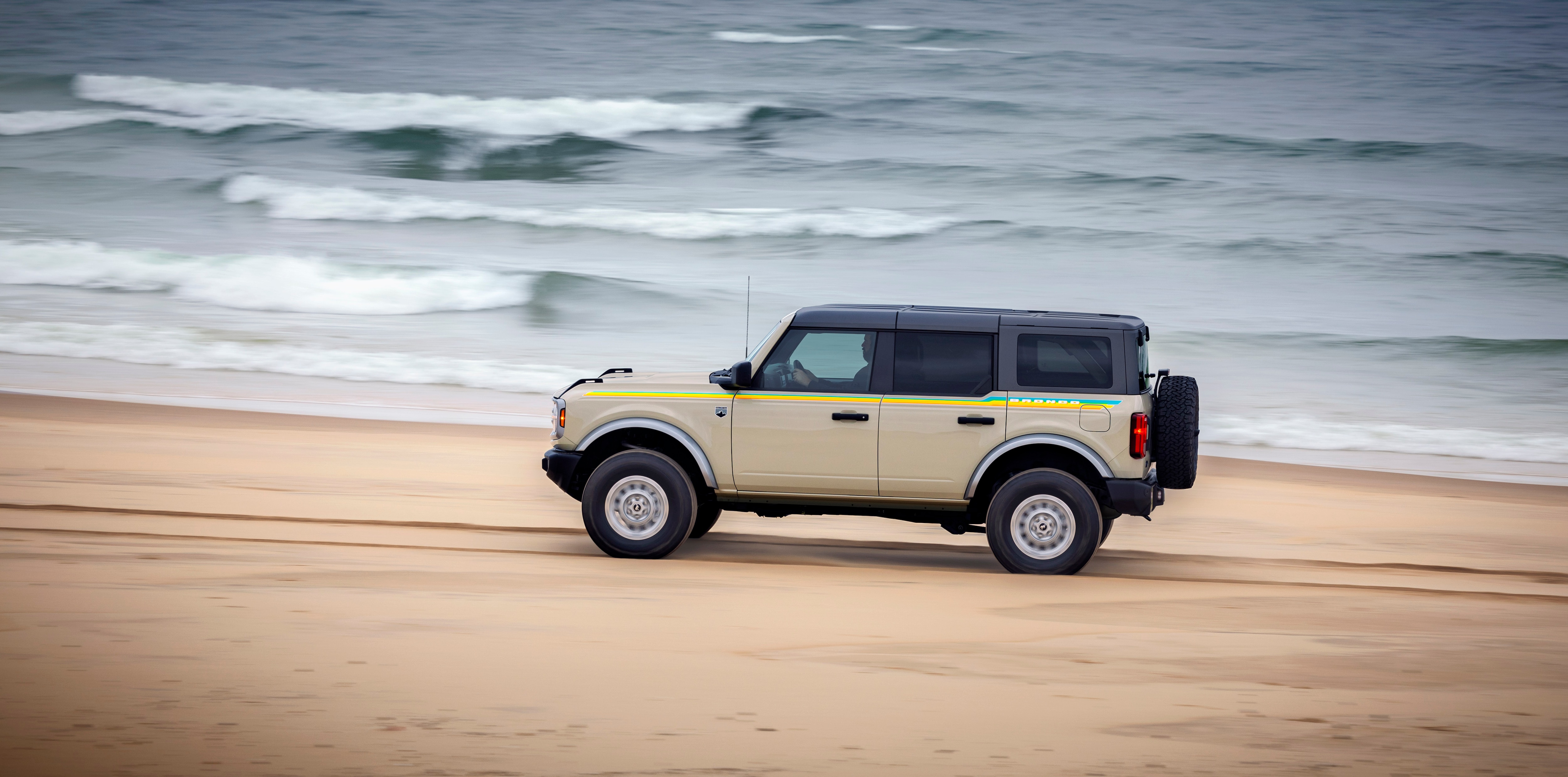 A Ford Bronco with the Ford Custom Garage Coastal Package is parked on the beach.